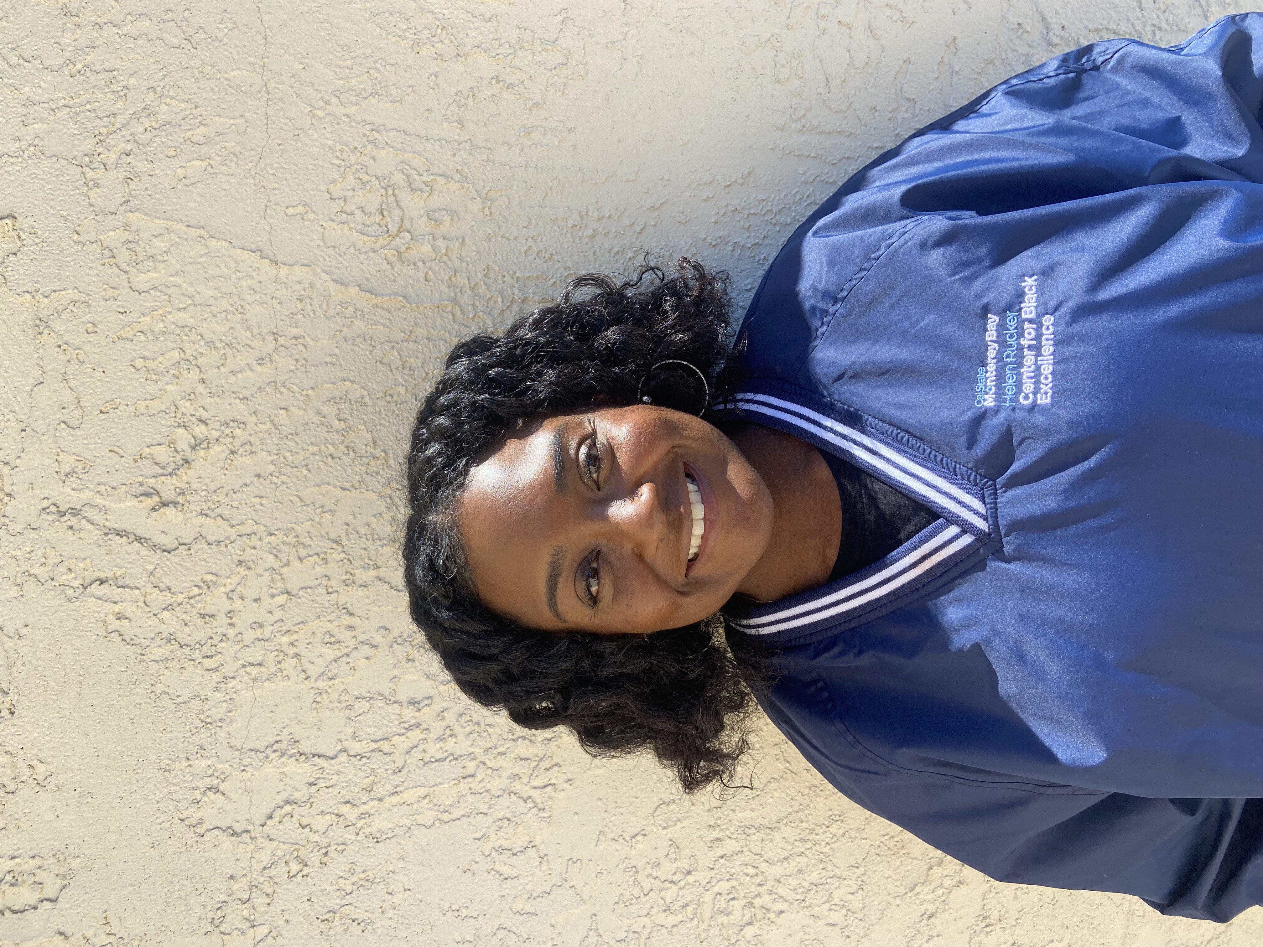 Staff member wearing navy blue windbreaker