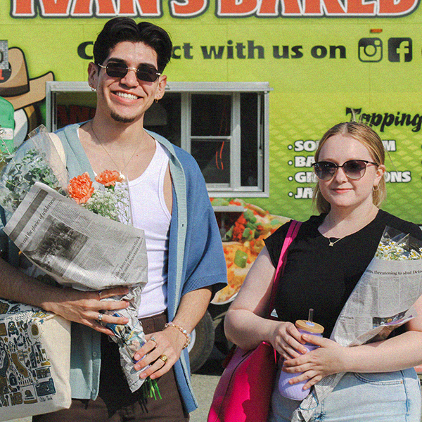 Two students buying flowers at the AS Farmers Market