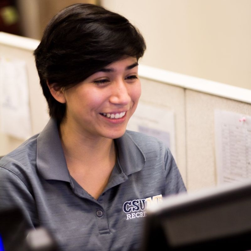 A person smiling at their computer