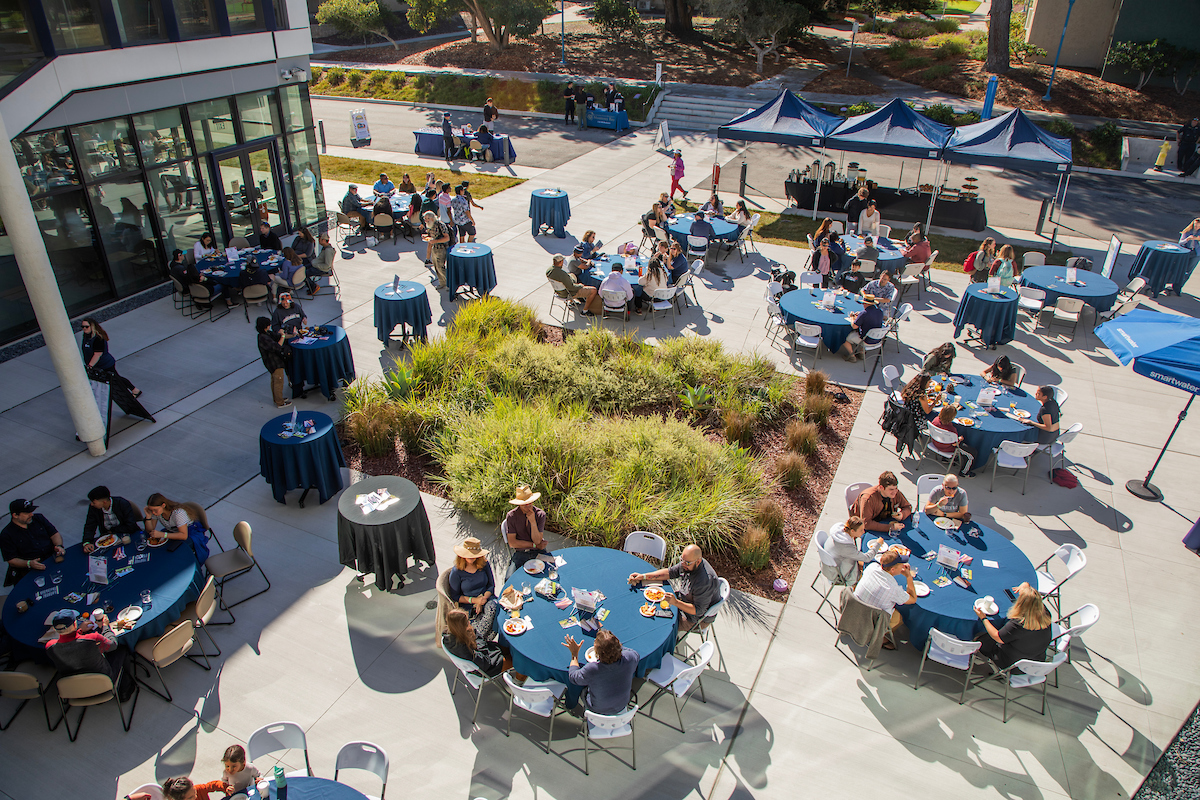 CSUMB students and faculty sitting for brunch at the OSU Plaza