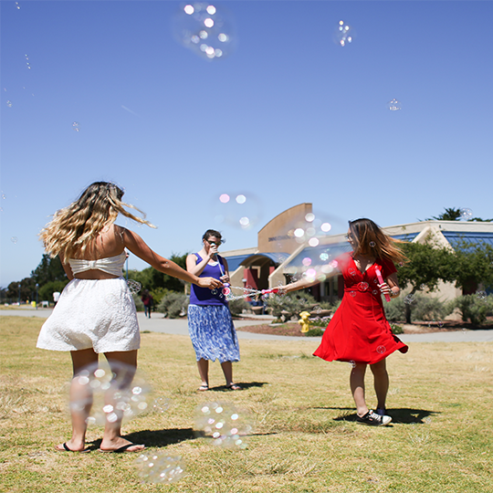Students playing with bubbles on the Main Quad.