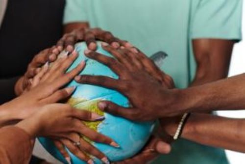 Hands on a globe.
