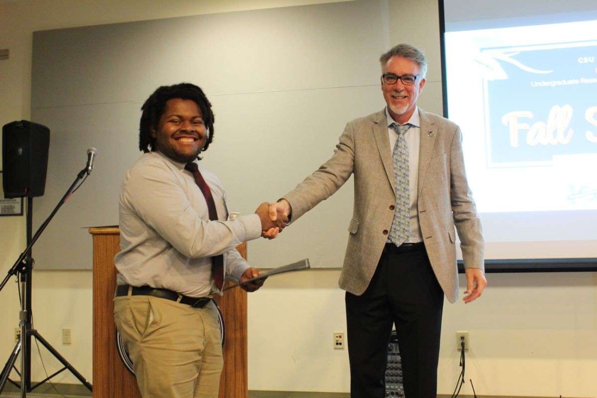 Frederick Siglar (left) shakes Dr. John Banks' hand during the fall showcase