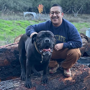 student posing for picture with dog