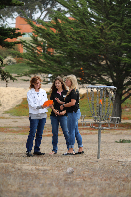 Group of people playing disc golf