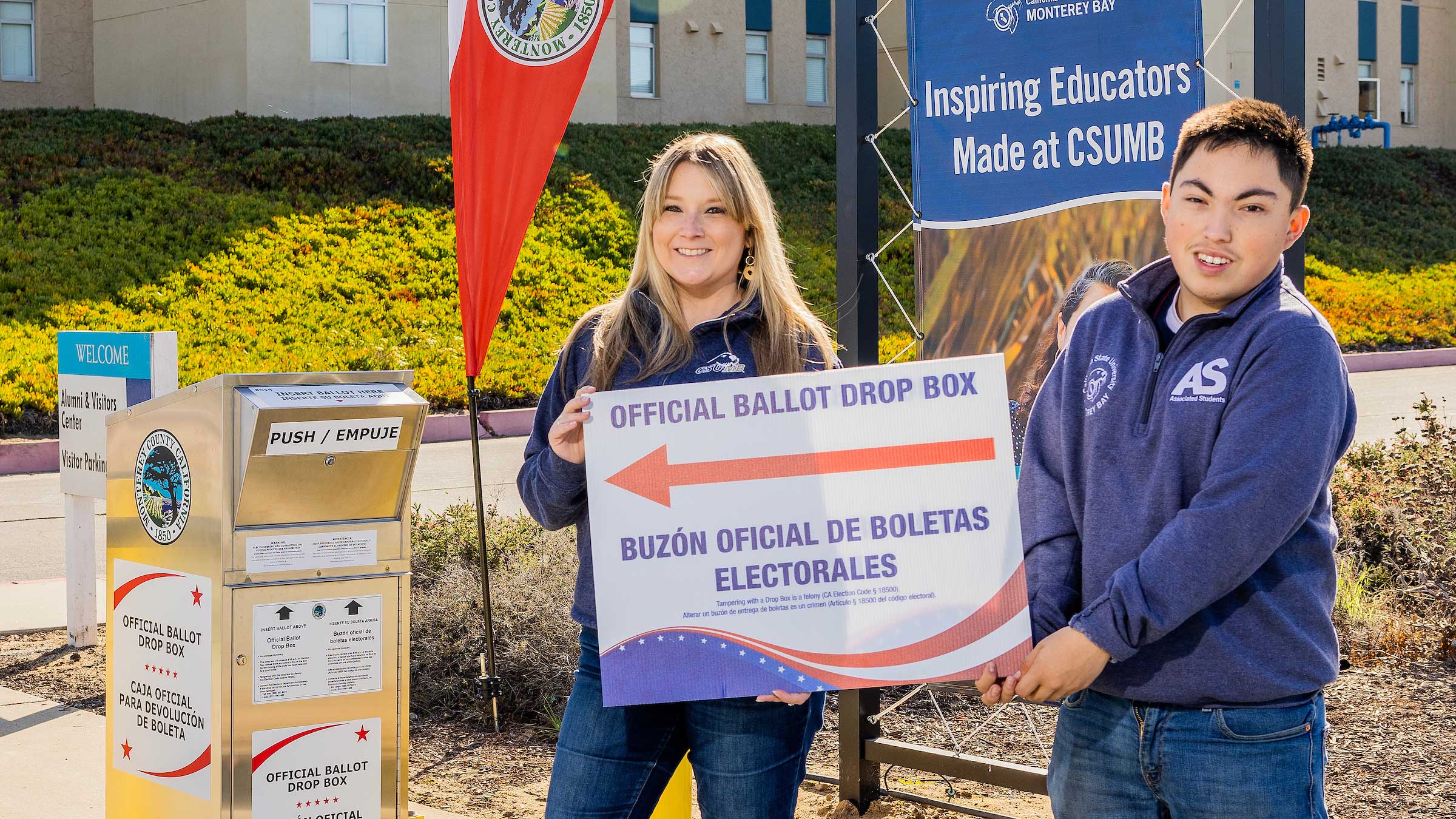 Nicole Hollingsworth and Javier Frias Origel next to an official ballot drop box