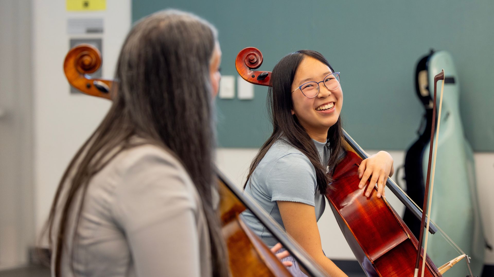 Cellist Averie Huang (right), 18, of Santa Cruz, gets tips on her playing from  Ameena Maria Khawaja during a California Orchestra Academy workshop