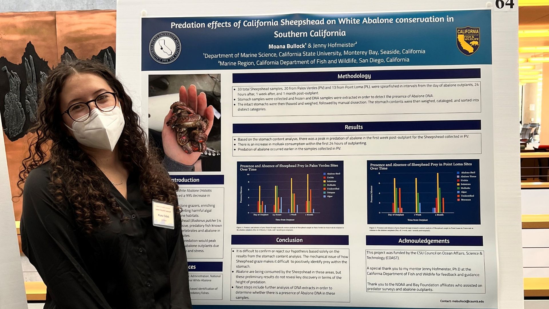 A Hispanic STEM grant recipient stands next to a research poster.