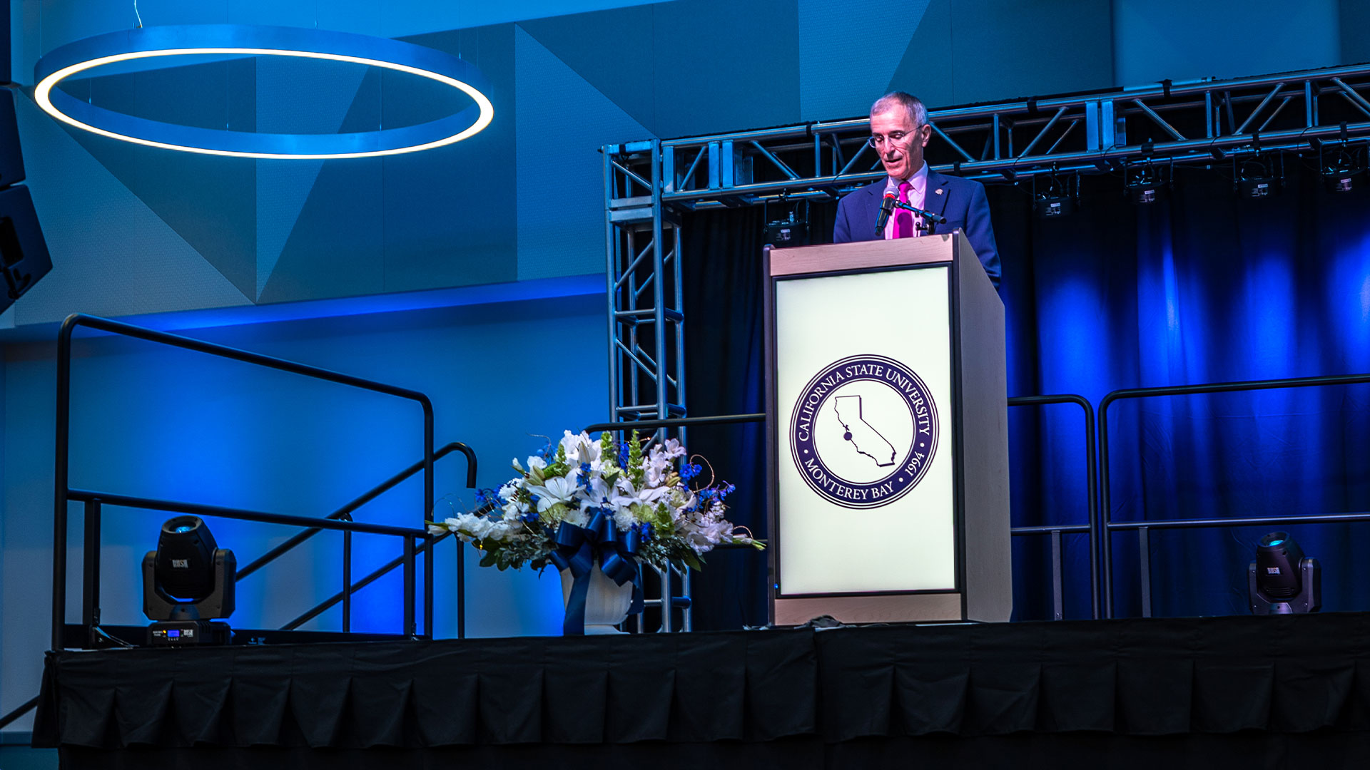 Photo: President Ochoa speaking at a podium during Day of Welcome employee event