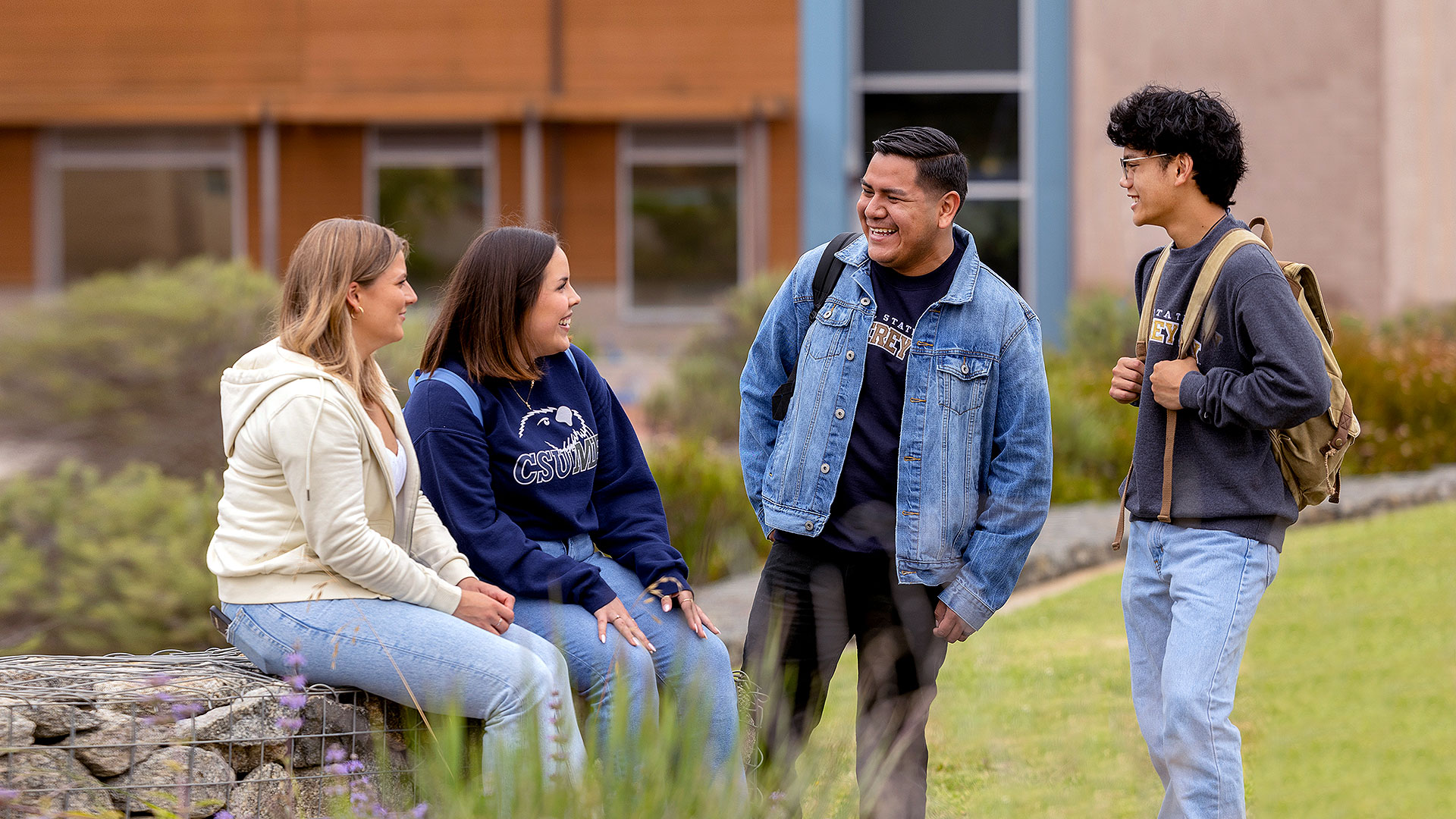 Four students hanging out together outside of the College of Science building Photo by Brent Dundore-Arias